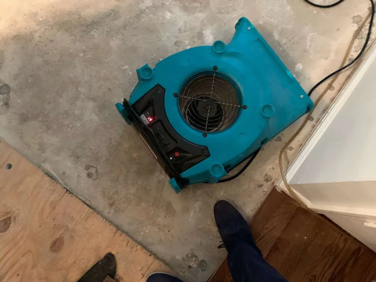 Air mover drying subfloor during Commercial Water Damage Restoration in Maryville